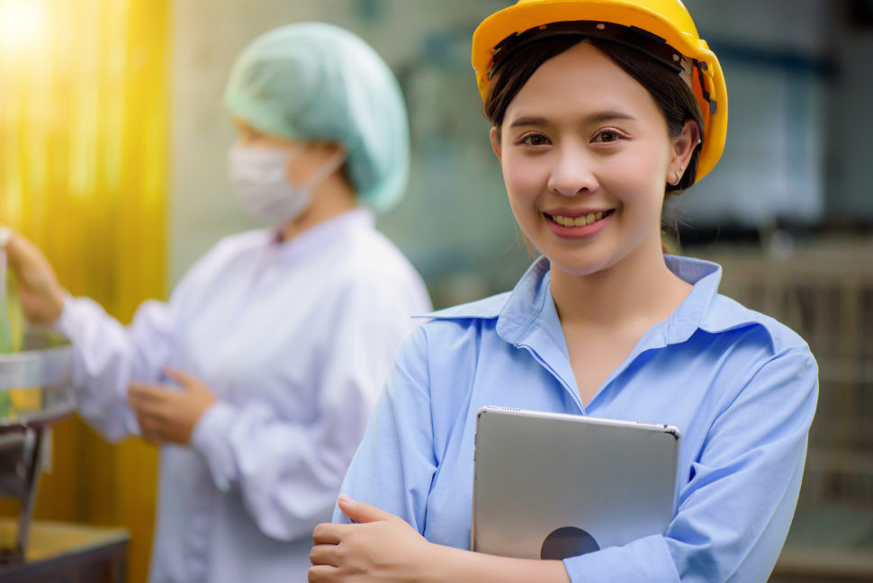 female construction worker holds ipad