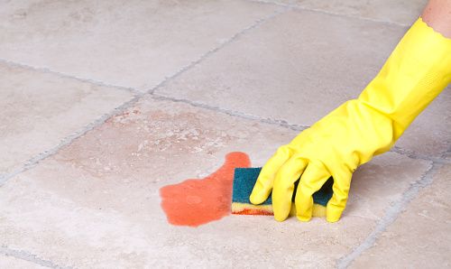 A food chemical safety image of a person cleaning a chemical spill.